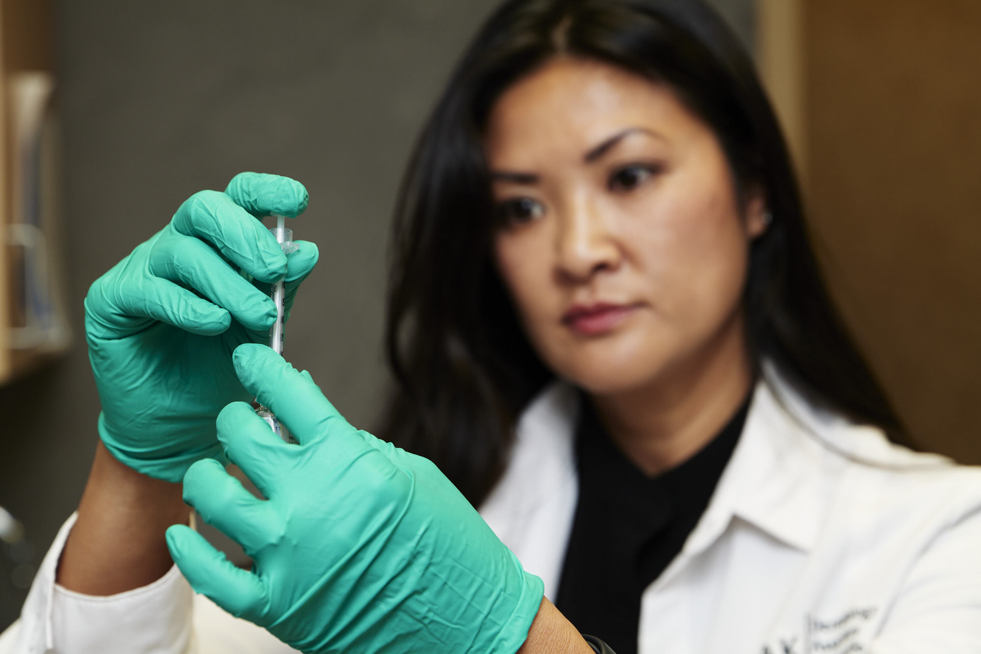 Cam wearing gloves and preparing a syringe